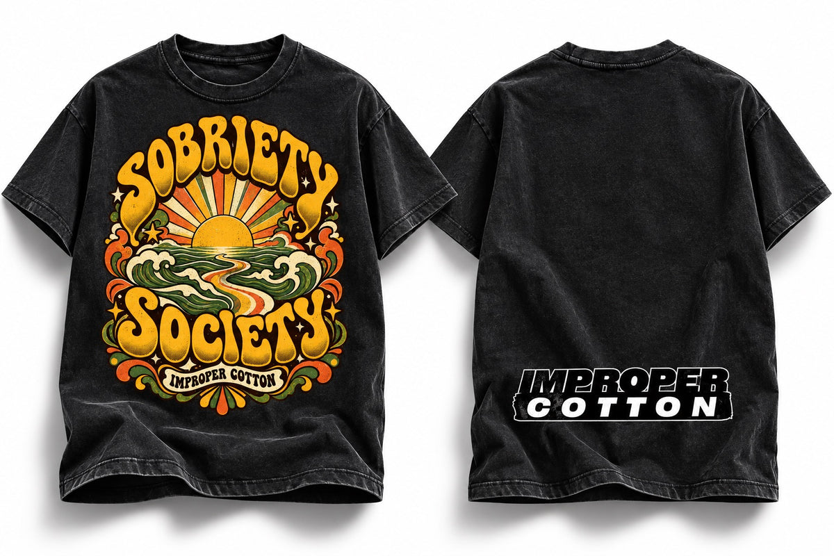 Two views of a black washed graphic t-shirt on a white background. The front features a large retro-style graphic with a yellow sun, green waves, and the text 'SOBRIETY SOCIETY' in yellow, with 'IMPOPER COTTON' below.