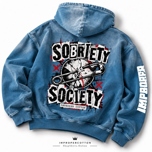A blue acid-wash hoodie shown from the back, featuring a large graphic print with the words 'SOBRIETY SOCIETY' and a syringe illustration, plus 'IMPROPER COTTON' printed down one sleeve.