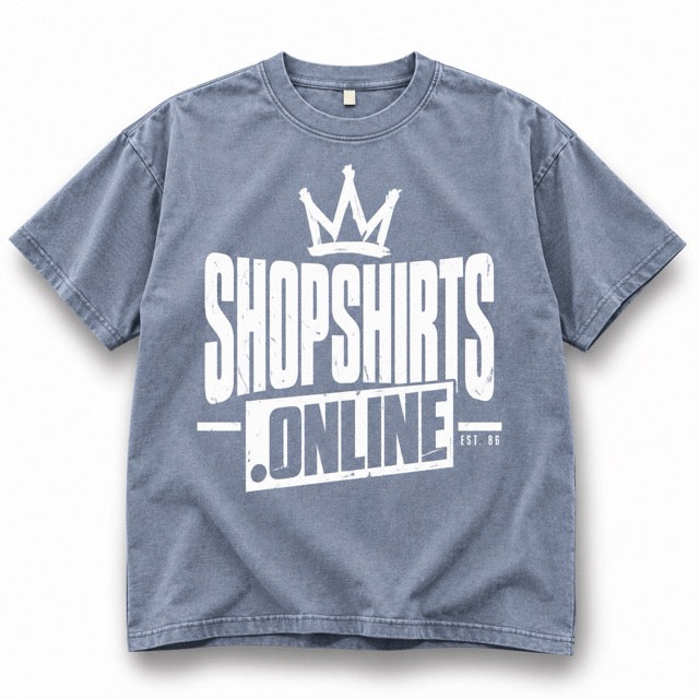Stone-washed blue-gray ShopShirts.online graphic T-shirt featuring a distressed white crown logo, bold ShopShirts.online lettering and EST. 86 detail on a clean white background with a soft shadow.