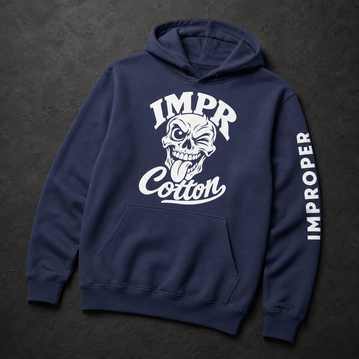 A navy blue pullover hoodie with a white graphic print on the front showing a skull and the text 'IMPR Cotton', plus 'IMPROPER' printed vertically down one sleeve, displayed on a dark textured background.