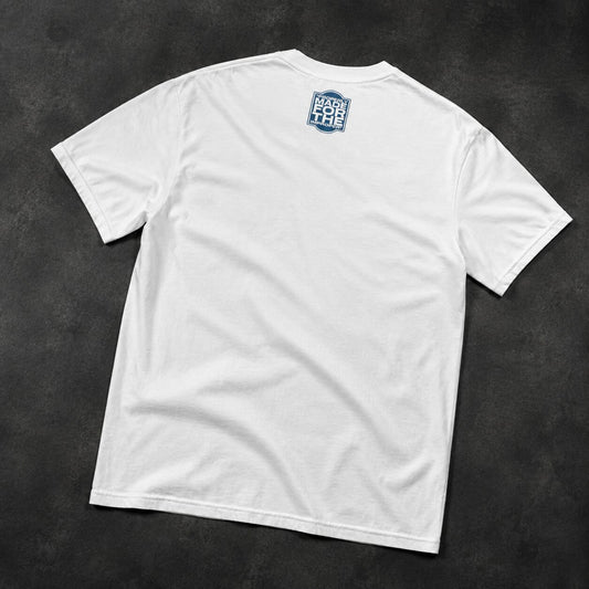 A white short-sleeve t-shirt shown from the back, laid flat on a dark textured background. A blue and white shield logo with the text 'BACK FOR THE' is printed on the upper center back.