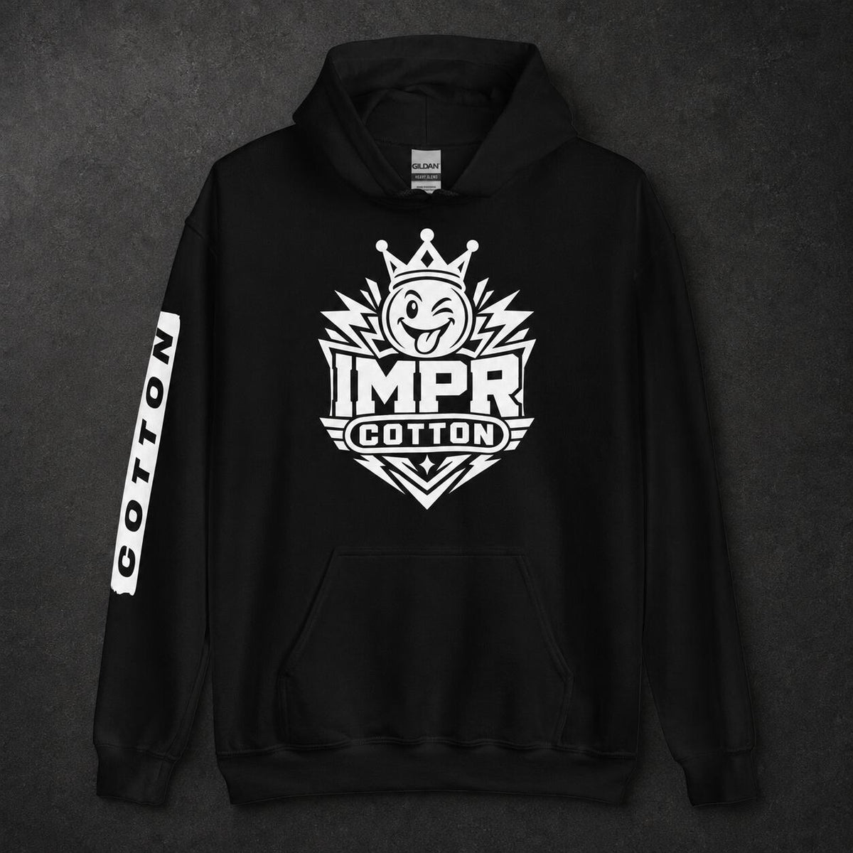 A black pullover hoodie with a large white graphic on the chest reading 'IMPR COTTON' beneath a cartoon character with a crown, plus a vertical white 'COTTON' print on one sleeve, shown against a dark textured background.