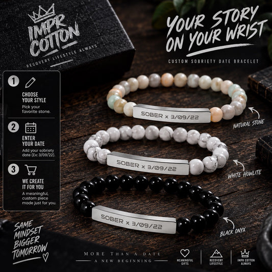 Three beaded sobriety date bracelets displayed on a dark wooden surface with a branded black box, promotional text, and step-by-step customization callouts. The bracelets use white, marbled white-and-gray, and glossy black beads, each with a silver rectangular plate engraved with 'SOBER x 3/3/22'.
