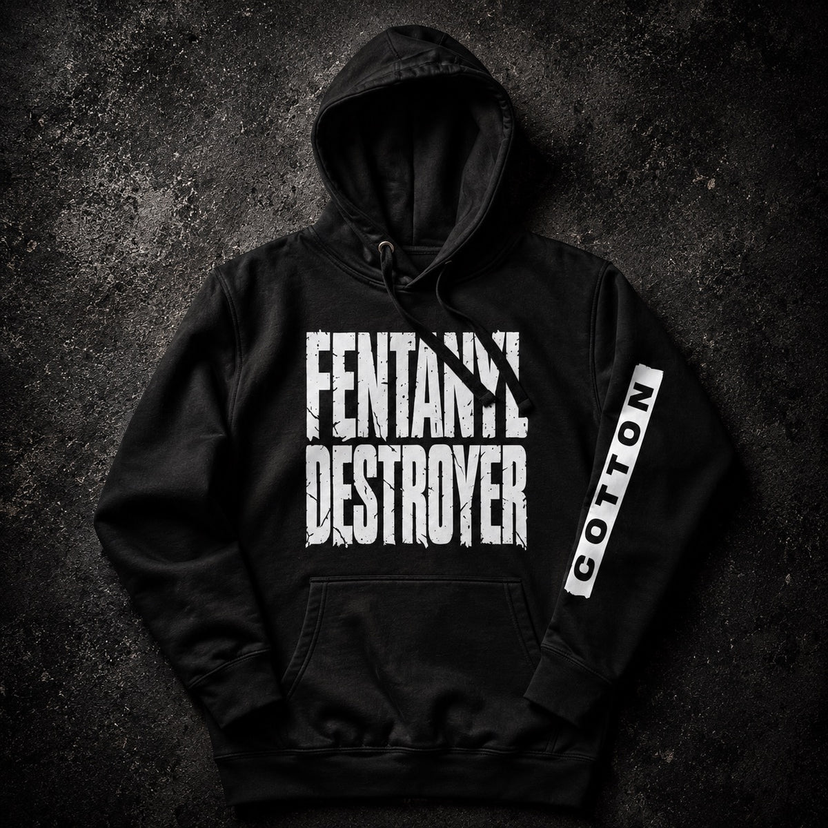 A black pullover hoodie laid flat on a dark textured background, featuring large distressed white text reading 'FENTANIL DESTROYER' across the chest and a vertical white sleeve print reading 'COTTON'.