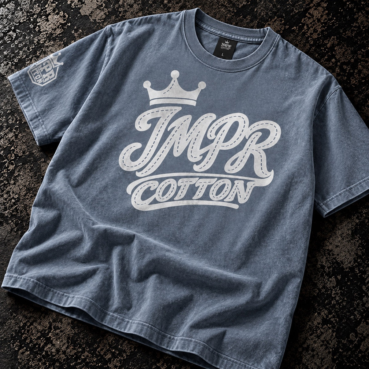 IMPR crown baseball logo graphic tee shirt laying on a dark table 