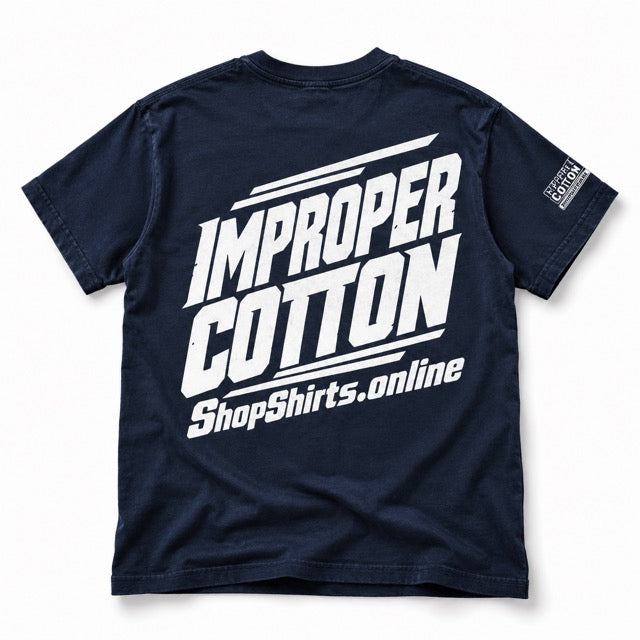 Back view of a navy IMPROPER COTTON graphic T-shirt featuring oversized white racing-style IMPROPER COTTON lettering and ShopShirts.online branding, displayed solo on a clean white background with a soft shadow.