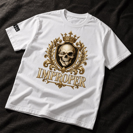 A white short-sleeve t-shirt laid flat on a dark textured fabric background. The shirt features a large gold and black graphic on the front depicting a crowned skull inside an ornate crest, with the word 'IMPROPER' printed below in a stylized gold font.