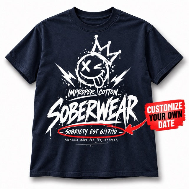 Navy Improper Cotton SOBERWEAR T-shirt featuring a crowned smiley recovery graphic and customizable sobriety date, shown on a clean white background with a soft shadow and personalized date callout.