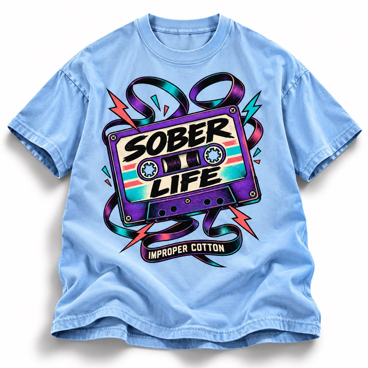 A light blue short-sleeve t-shirt with a colorful graphic of a cassette tape that reads 'SOBER LIFE' and 'IMPROPER COTTON' underneath, set against a plain white background.