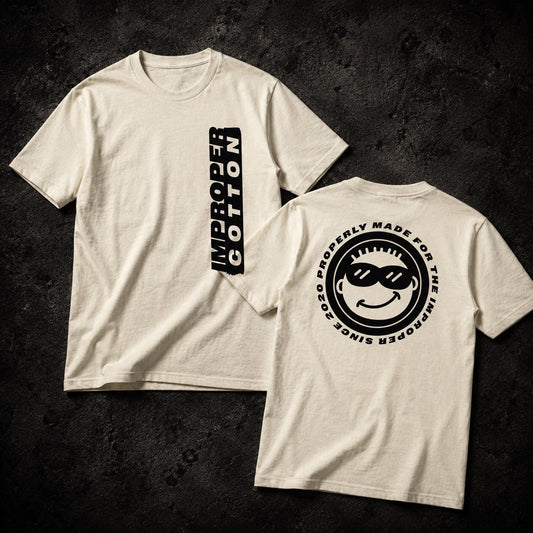 Two off-white short-sleeve t-shirts shown on a dark textured background, displaying the front and back designs. The front features a vertical black graphic reading 'IMPROPER COTTON'.