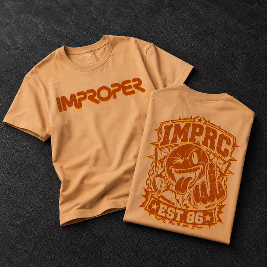 Two tan crewneck t-shirts displayed on a dark textured background, showing the front and back designs. The front features the word 'IMPROPER' in a bold orange-to-brown gradient.
