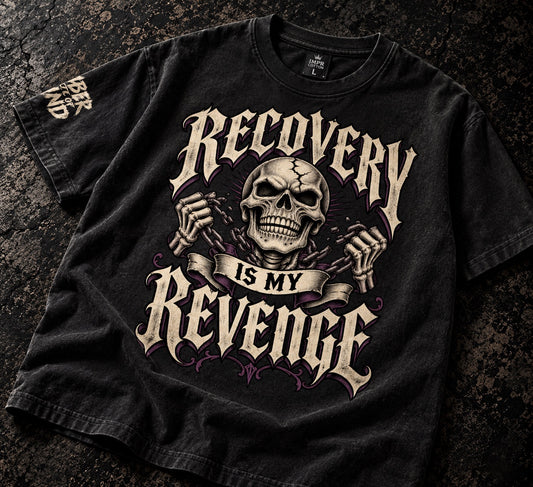 Recovery is my revenge vintages washed black graphic skull graphics tee laying on dark table