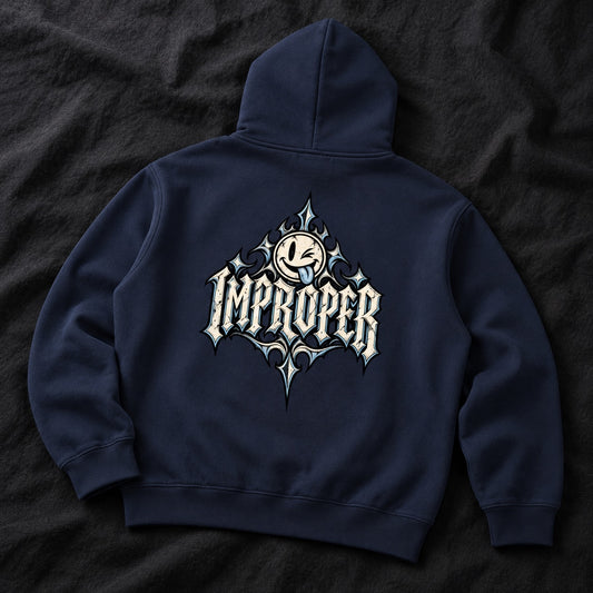 A navy blue hoodie laid flat on a dark charcoal background, showing the back view with a large graphic print. The graphic features the word 'IMPROPER' in stylized white and silver gothic lettering with a circular emblem above it.