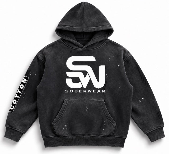 A black acid-wash hoodie with a large white 'SW' logo and 'SOBERWEAR' text on the chest, featuring a front kangaroo pocket and a vertical 'COTTON' sleeve print.
