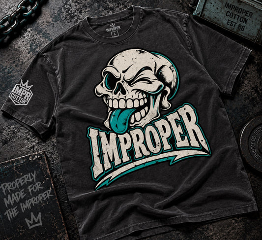 Skull out impropercotton black graphic tee laying on a dark wooden table ShopShirts graphic tees