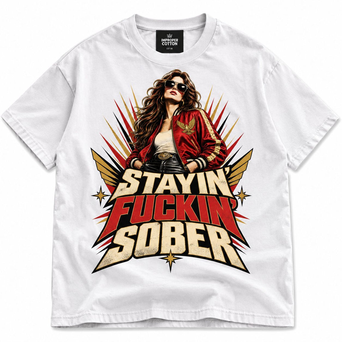 A white short-sleeve crewneck t-shirt featuring a large graphic print of a woman in a red bomber jacket and sunglasses, with the text 'STAYIN' FUCKIN' SOBER' in bold red, gold, and black lettering.