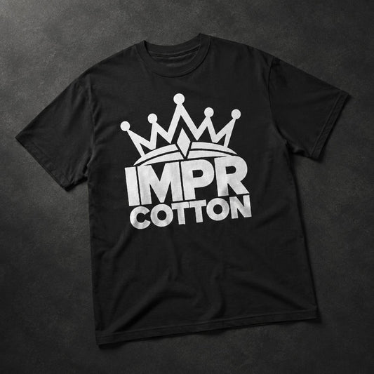 A black short-sleeve t-shirt laid flat on a dark textured background, featuring a white graphic of a crown above the words 'IMPR COTTON' in bold white letters.