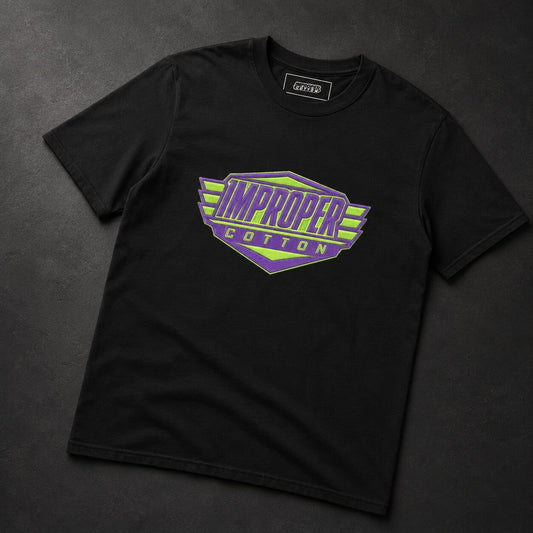 A black short-sleeve t-shirt with a colorful graphic on the chest reading 'IMPROPER COTTON' in purple and lime green, laid flat on a dark textured background.