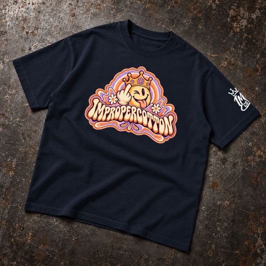 A navy blue t-shirt laid flat on a textured, dark metallic surface, showing the back graphic. The graphic features a psychedelic candy trippy logo saying impropercotton 