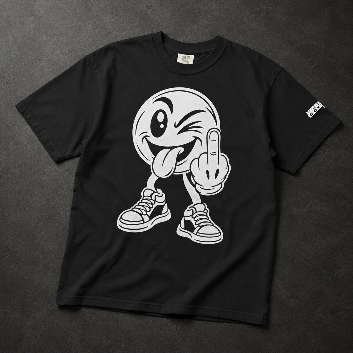 A black short-sleeve t-shirt laid flat on a dark textured background, featuring a large white graphic of a winking cartoon face with its middle finger and sneakers. A small white logo is printed on the left sleeve.