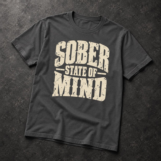 A dark charcoal gray t-shirt with a distressed cream-colored graphic reading 'SOBER STATE OF MIND' laid flat on a dark textured background.
