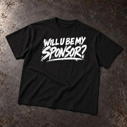 A black short-sleeve t-shirt with the phrase 'WILL U BE MY SPONSOR?' printed in a bold white brush-stroke font across the chest, laid flat on a textured dark gray surface.